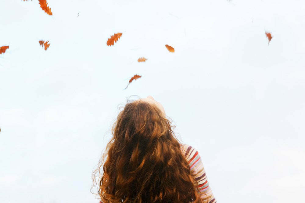 Fall Picture of leaves and woman with back of hair showing